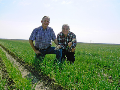Two men (Bruce Frasier on left and Jerry Parsons) out standing in their field